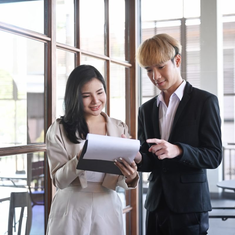 two-financial-workers-sharing-idea-and-working-together-at-office-.jpg